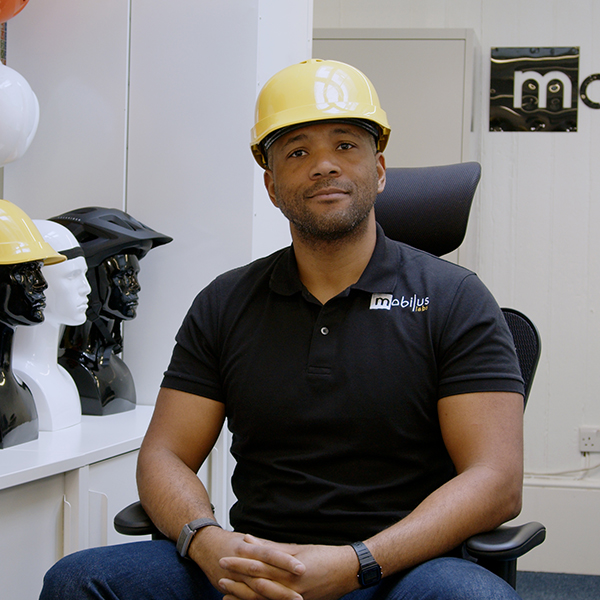 A photo of Jordan McRae sitting in a chair with a hard hat on