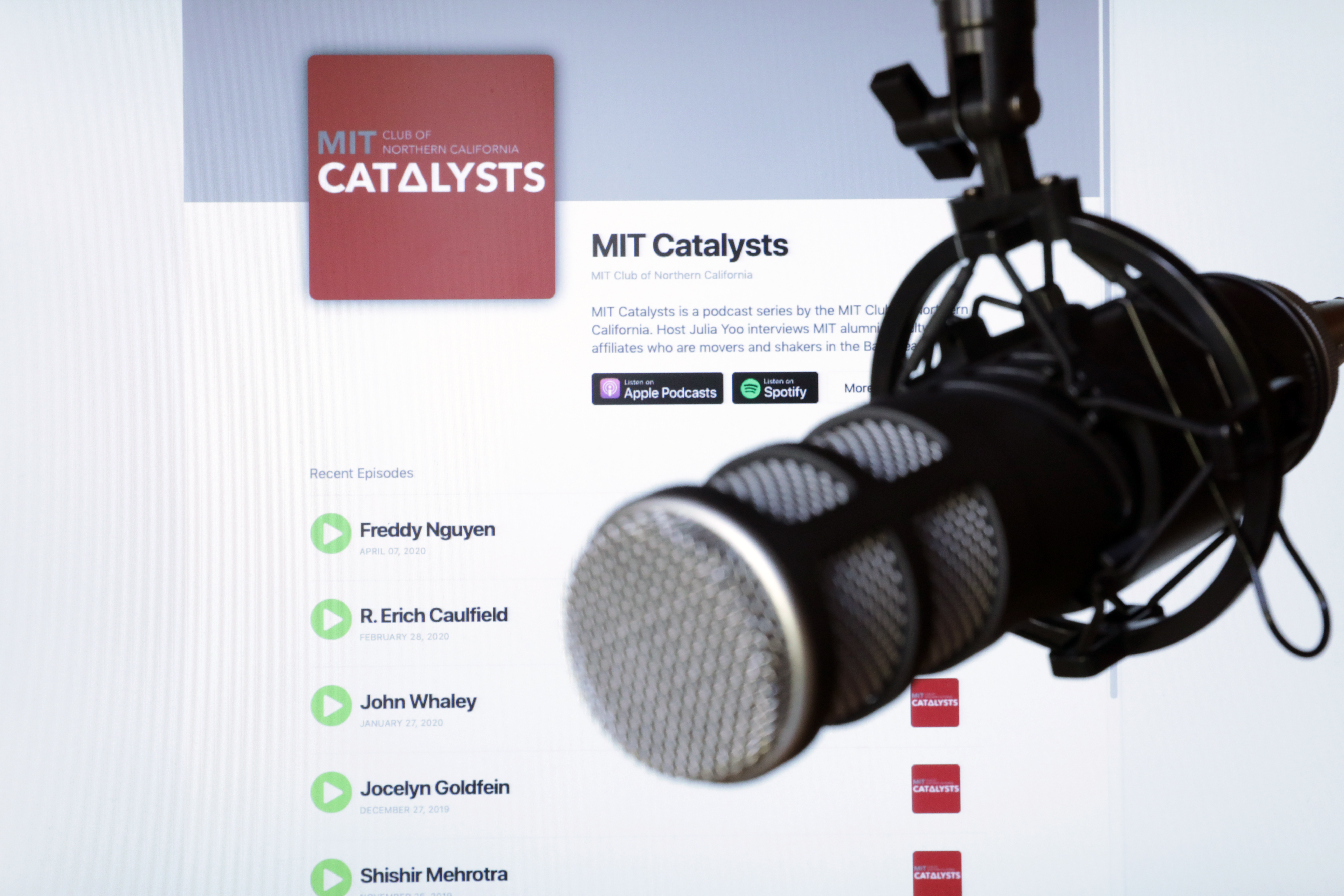 A microphone in front of a screen that displays the MIT Catalysts podcast web page