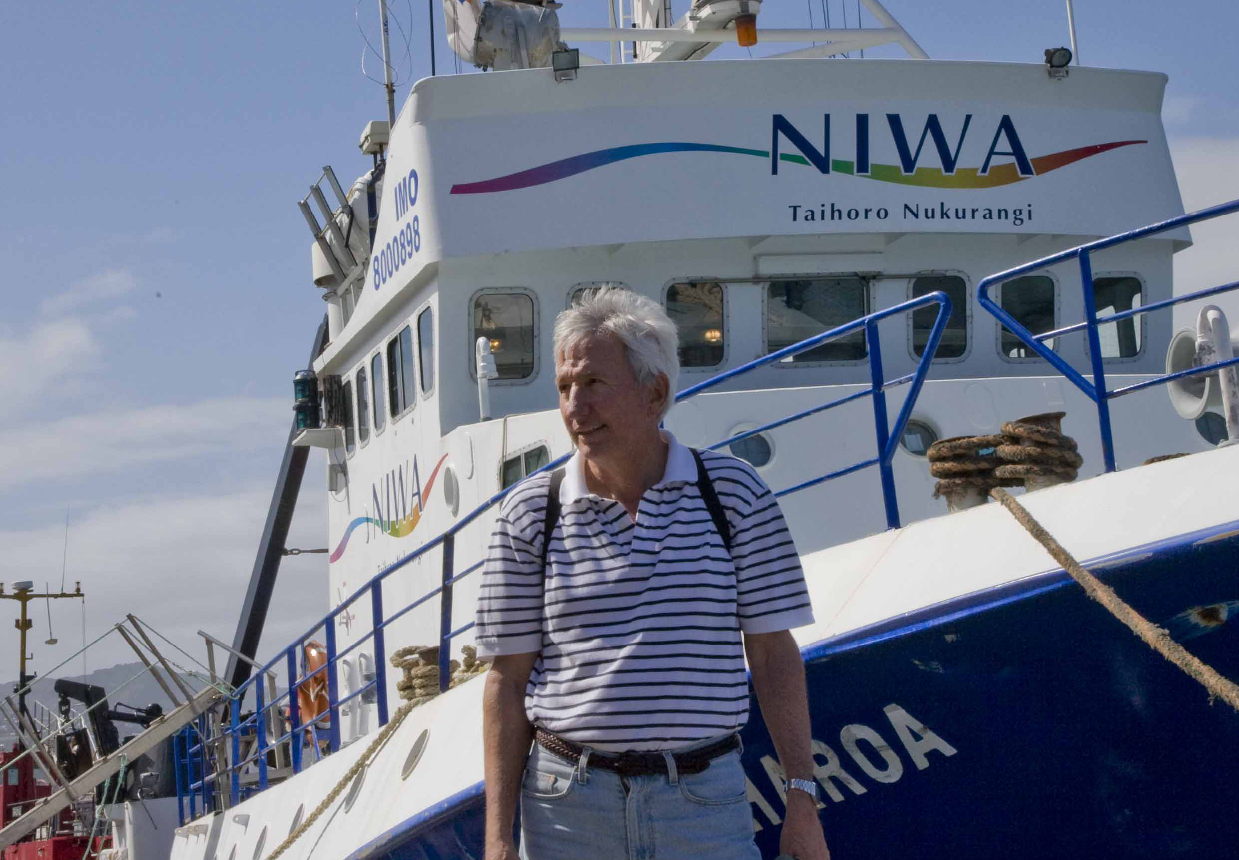 Dean Roemmich posing in front of a boat in New Zealand