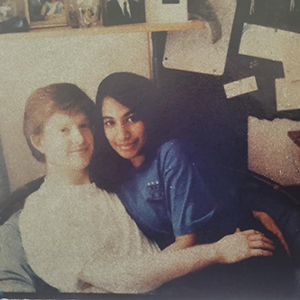 A photo of Eric Hankwitz and Bandita Joarder sitting together on a chair in a dorm room