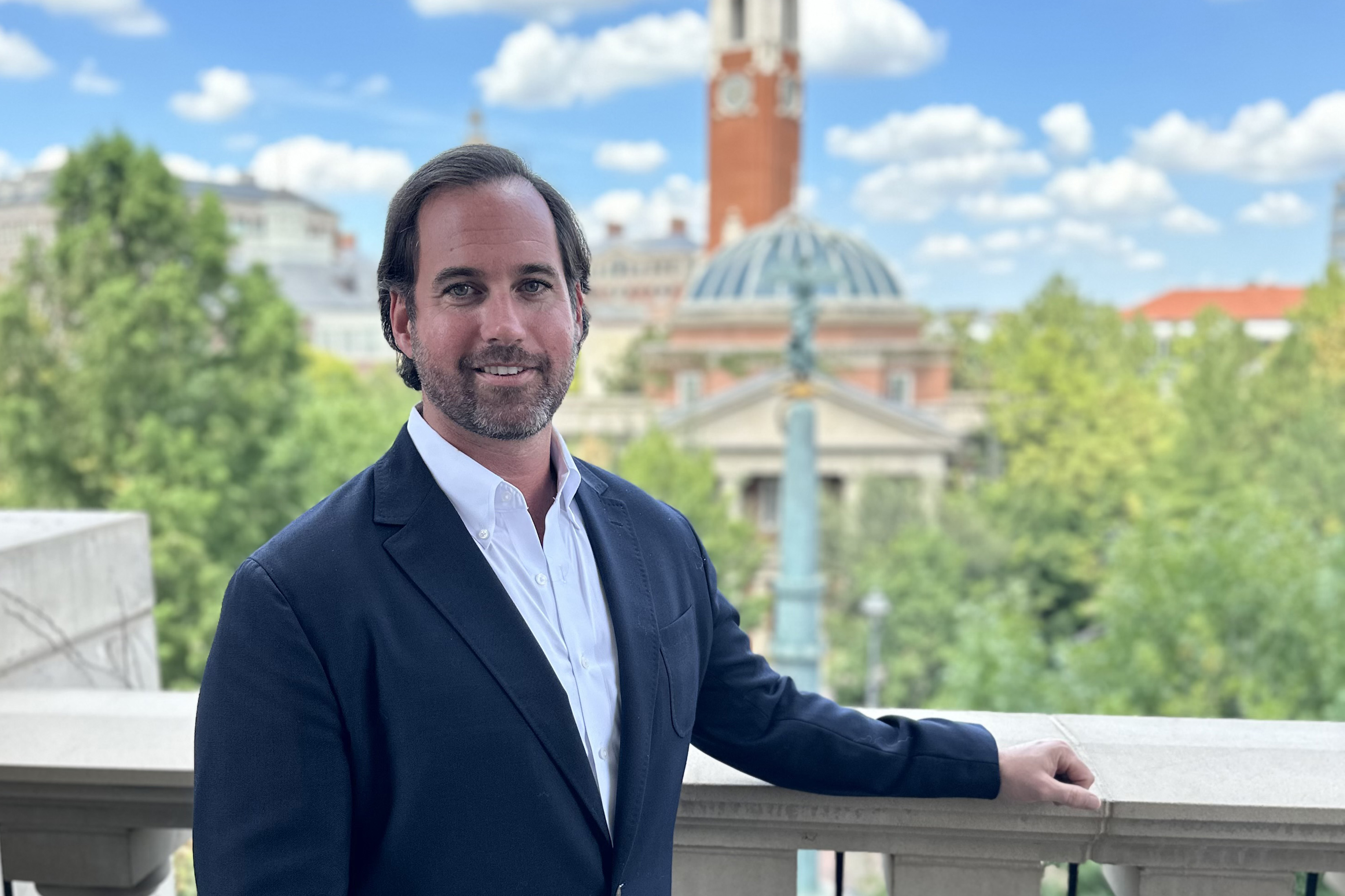 Portrait of Edward Crawford on a balcony with a building in the background.