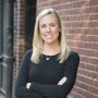 MIT alumna Kate Cincotta standing outside in front of a brick wall